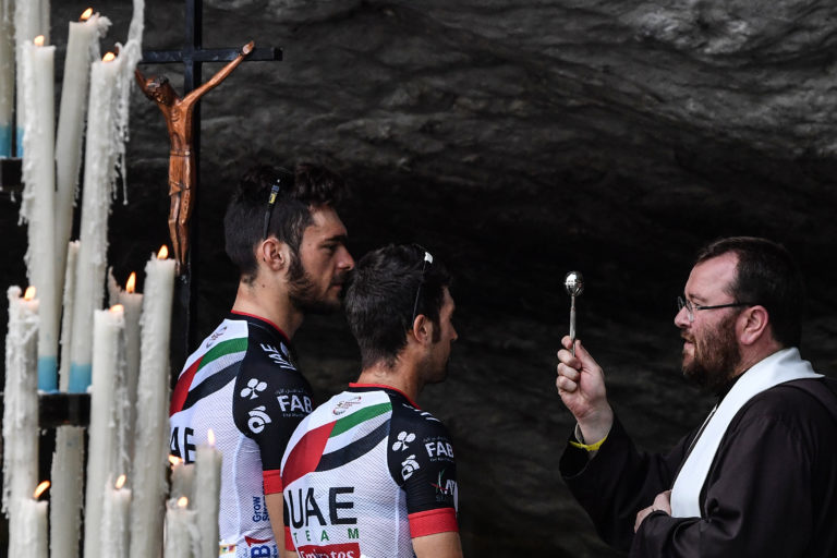 A priest blesses Italy’s Oliviero Troia (L) and Italy’s Marco Marcato (Getty Images)
